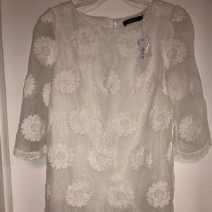 Sheer arm details. Bright white. Never been worn!